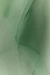 Kaboompics - Sage green sheer fabric seam detail, soft draped texture