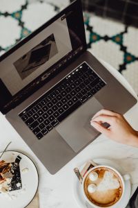 Kaboompics - Working with a laptop, meringue with whipped cream and coffee on white marble