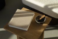 Kaboompics - Neutral Reading Corner with Blank Book, Wooden Side Table and Decorative Bowl