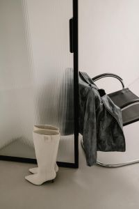 Kaboompics - White Knee-High Boot and Leather Jacket by Chair