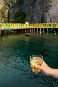 Kaboompics - Green-Yellow Pier Railing over Water with Glass at Edge