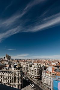 Kaboompics - Vertical Madrid Rooftop Cityscape Beneath Wispy Blue Clouds