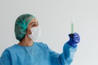Kaboompics - Female Lab Technician Examining Green Liquid in Graduated Cylinder