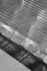 Kaboompics - Ribbed Glass Panel Edge over a Deep Textured Cast Shadow