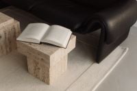 Kaboompics - Open Book on Travertine Pedestal beside Black Leather Sofa