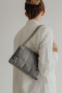 Kaboompics - Woman in White Blazer Carrying a Gray Quilted Chain Strap Bag, Minimal Fashion