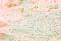 Kaboompics - Wide Mint and Blush Cream Texture with Scattered Exfoliating Granules