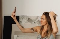 Kaboompics - Woman Taking a Selfie While Relaxing on a Sofa at Home