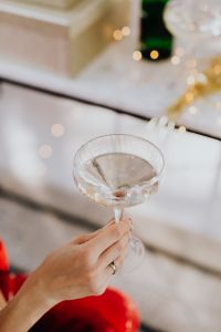 Kaboompics - Hand Holding Champagne Glass Against Festive Bokeh