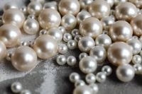 Kaboompics - Iridescent Pearl Beads on Gray Textured Background