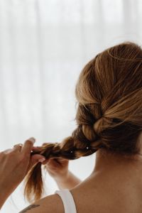 Kaboompics - Hands Securing a Braid with a White Scrunchie