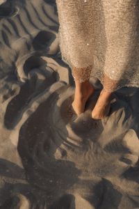 Kaboompics - Barefoot Woman in Sequin Dress on Rippling Beach Sand