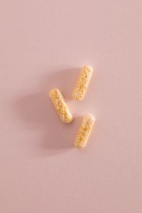 Kaboompics - Three Bead-Filled Capsules on a Pink Background