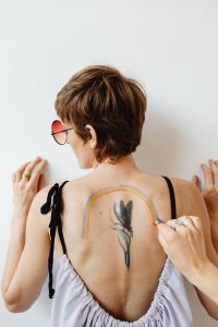 Kaboompics - Rainbow Arch Painted Around a Botanical Back Tattoo