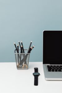 Kaboompics - Black Watch, MacBook and Pencil Cup in a Work Desk Flat Lay