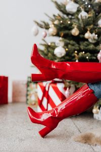 Kaboompics - Crossed Red Boots with Glowing Christmas Tree Background