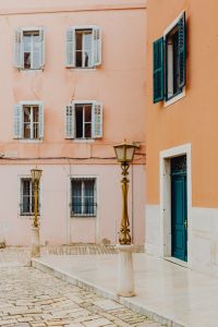 Kaboompics - Pastel Pink Rovinj Facade with Turquoise Shutters and Ornate Street Lamps