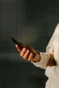 Kaboompics - Woman Holding Smartphone in Minimal Interior