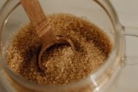 Kaboompics - Brown Sugar in a Glass Jar with Wooden Spoon, Close-Up Baking Ingredient Texture