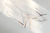 Kaboompics - Eyeglasses With Overlapping Frames And Shadows On Marble