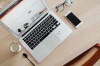 Kaboompics - Photographer Workspace Flat Lay with Laptop, Smartphone and Eyeglasses on a Light Wood Desk
