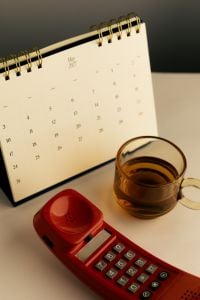 Kaboompics - May 2027 Desk Calendar With Red Retro Telephone and Tea