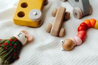 Kaboompics - Close-Up of Wooden Puzzle Cars and Colorful Bead Toy