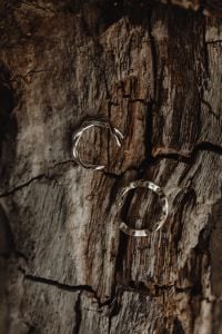 Kaboompics - Two Silver Rings on Dark Bark, Rustic Jewelry Product Photo