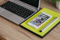 Kaboompics - Silver Acer Laptop, White Apple iPhone And Pencils On Yellow Notebook
