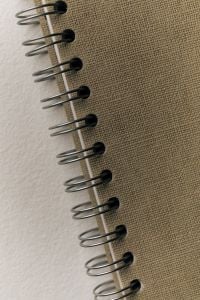 Kaboompics - Spiral Notebook Binding Detail on Neutral Background