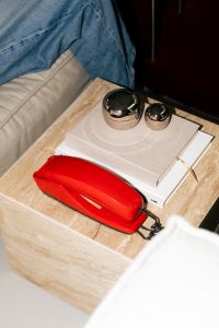 Kaboompics - Styled Side Table With Red Phone Books And Metallic Objects