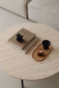 Kaboompics - Kinfolk Coffee Table Book and Candle on a Travertine Living Room Table