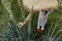 Kaboompics - Woman in White Dress and Red Floral Shoes among Tall Summer Grasses