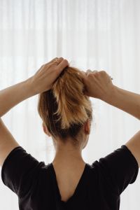 Kaboompics - Hands Gathering Hair into a High Ponytail