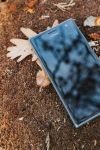Black mobile phone on the ground