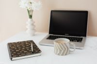 Kaboompics - White Flowers and Coffee beside a Laptop with Open Desk Space