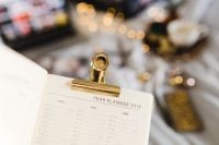 Kaboompics - 2018 Year Planner on White Bedding with Gold Clip and Soft-Focus Laptop, Home Office Lifestyle