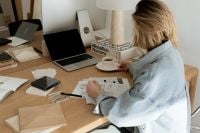 Kaboompics - Interior Designer Sketching at a Material Selection Worktable