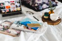 Kaboompics - Bed full of pillows and notebooks with Apple gadgets