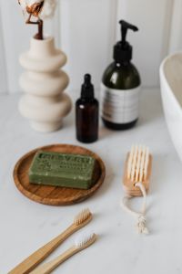 Kaboompics - Essential Oil Bottles and Sculptural Ceramic Vase on Bathroom Vanity, Neutral Beauty Product Photo