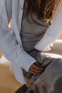 Kaboompics - Ringed Hand on Silver Satin Skirt and White Linen Shirt, Beach Fashion Detail