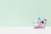 Kaboompics - Shopping Basket with Beauty Products on Mint Green Background