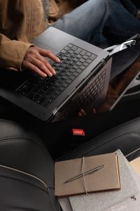 Kaboompics - Working on a Laptop in a Car With Journaling Notebooks
