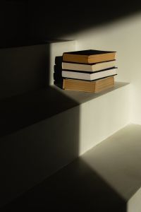 Kaboompics - Moody Interior Still Life with Stack of Books and Window Light