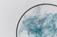 Kaboompics - Plastic Fragments Macro In Scientific Glass Dish Minimal Background