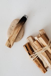 Kaboompics - Palo Santo Stick on Stone with Bundled Wood for a Cleansing Ritual