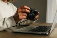 Kaboompics - Camera on Desk With Remote Worker Using Laptop