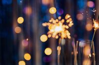 Kaboompics - Single Sparkler Glow with Amber Bokeh on Navy Blue Copy Space