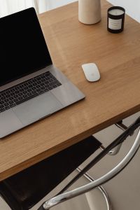 Kaboompics - Laptop, Stone Lamp and Candle on Neutral Wooden Desk
