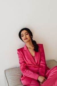 Kaboompics - Seated Asian Businesswoman in Pink Satin Suit
